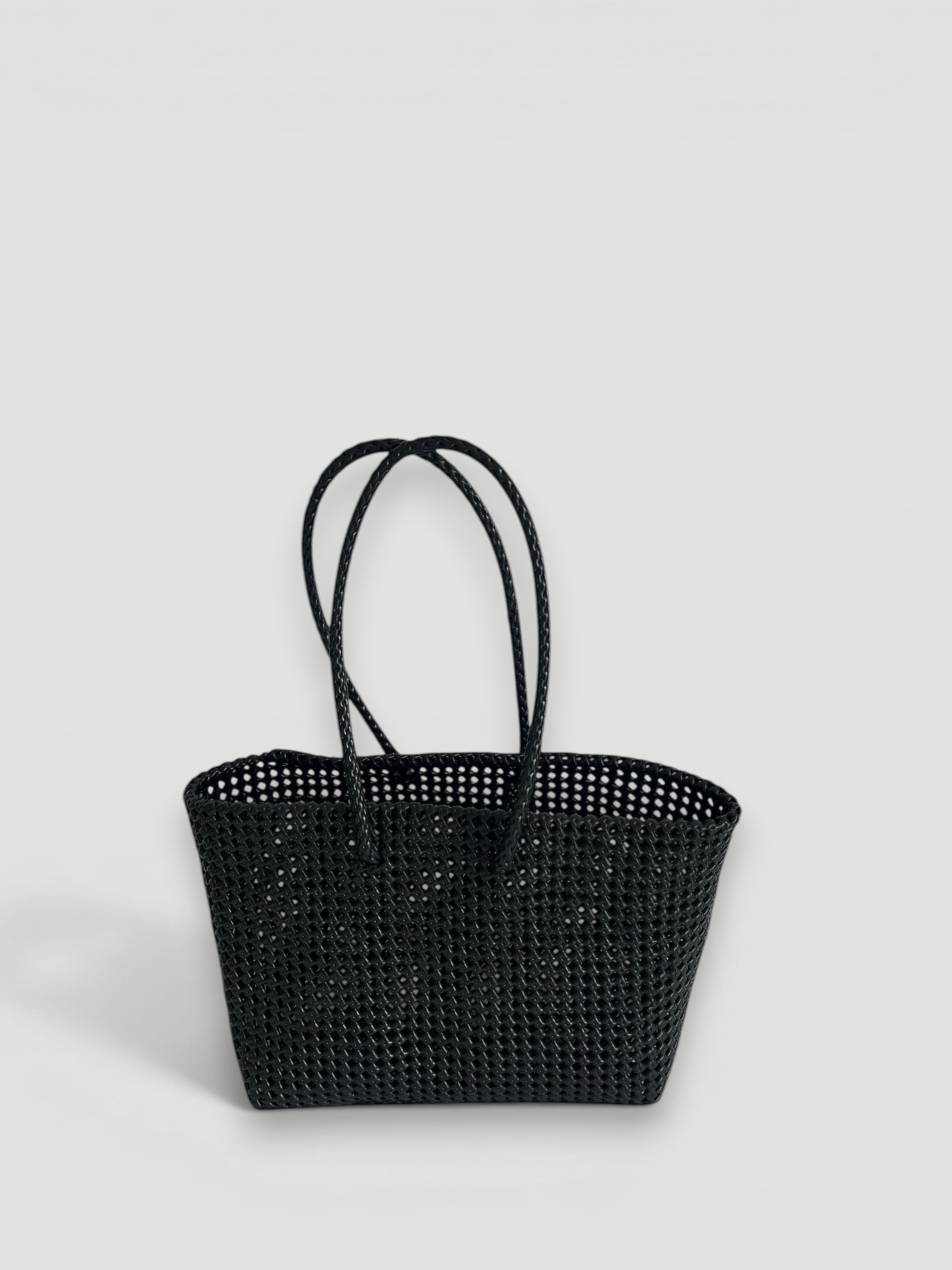 MOKA large black woven tote bag made from recycled plastic and silk with braided handles.