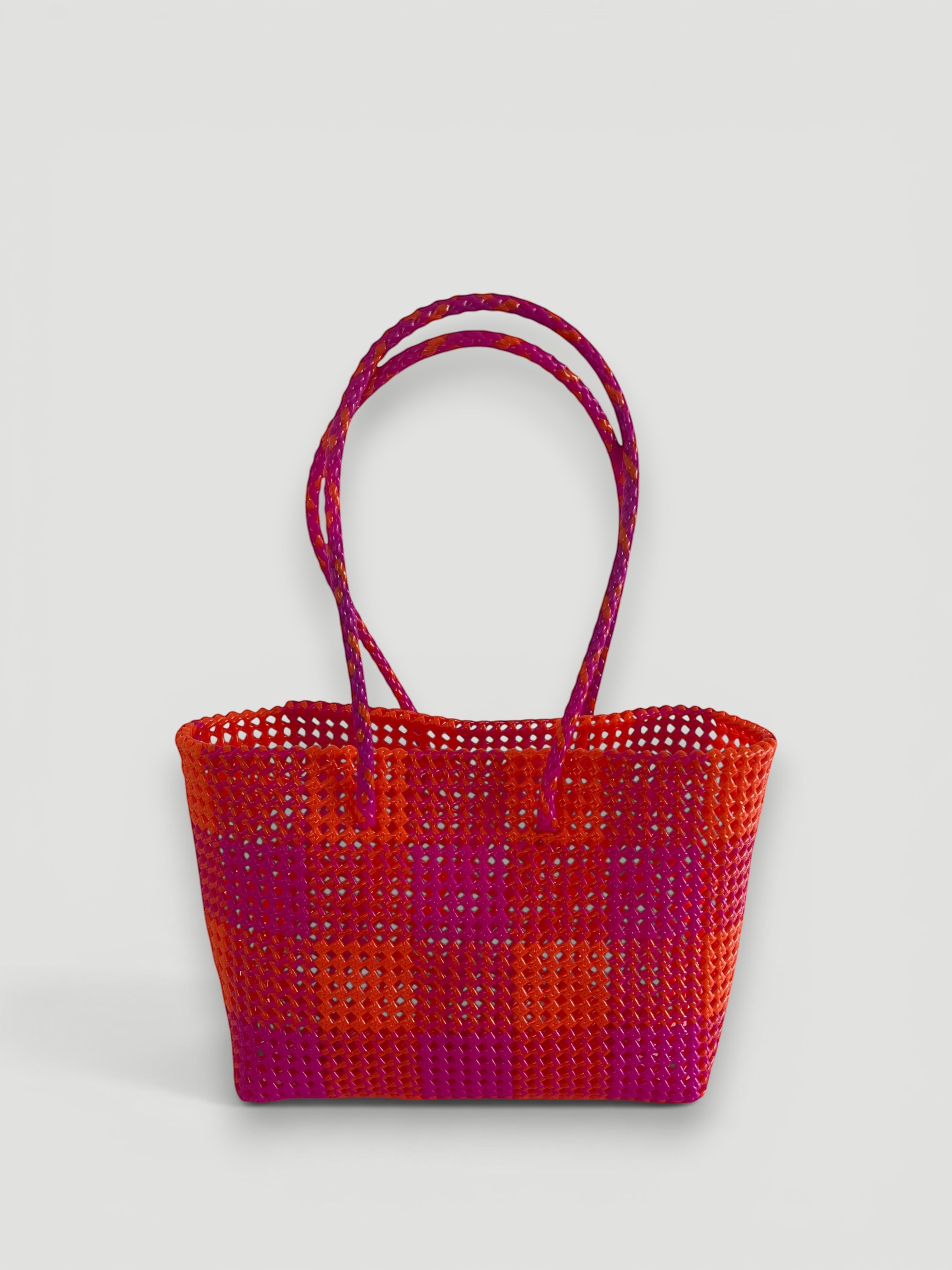 MOKA large hand-woven basket bag in dark pink and orange recycled plastic and silk with braided handles.