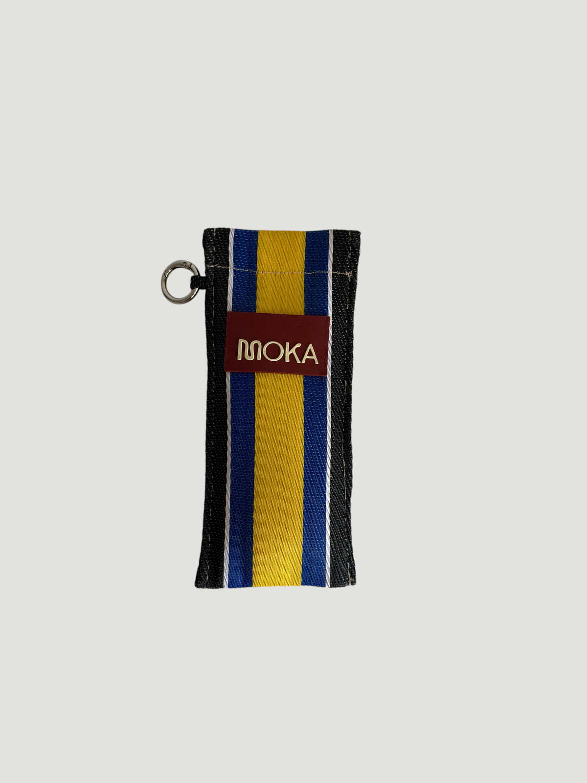 Étui à lunettes MOKA modèle COBALTO en matériaux recyclés rayés bleu, jaune et noir avec étiquette logo